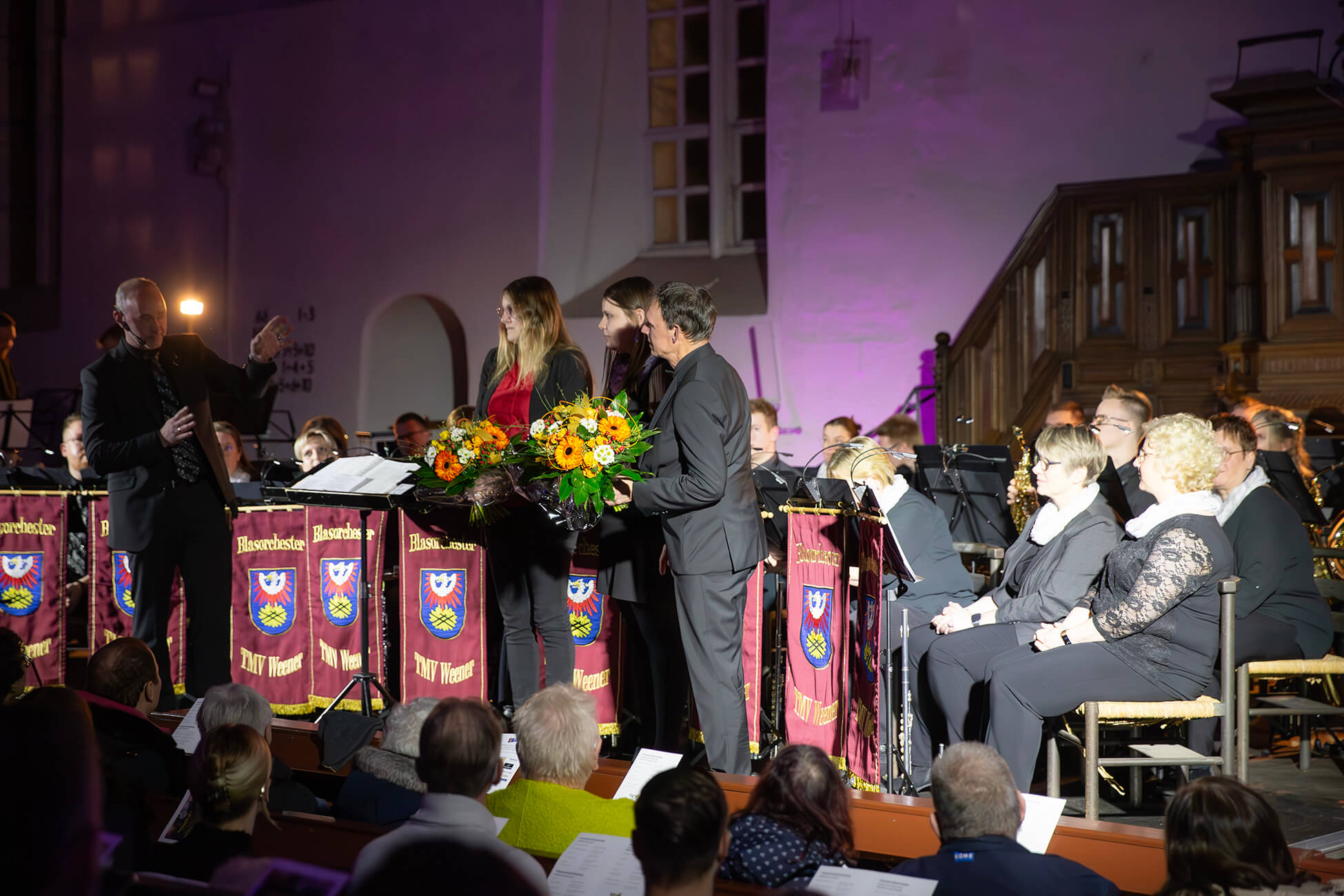 Chris standing up holding his daughter Elva